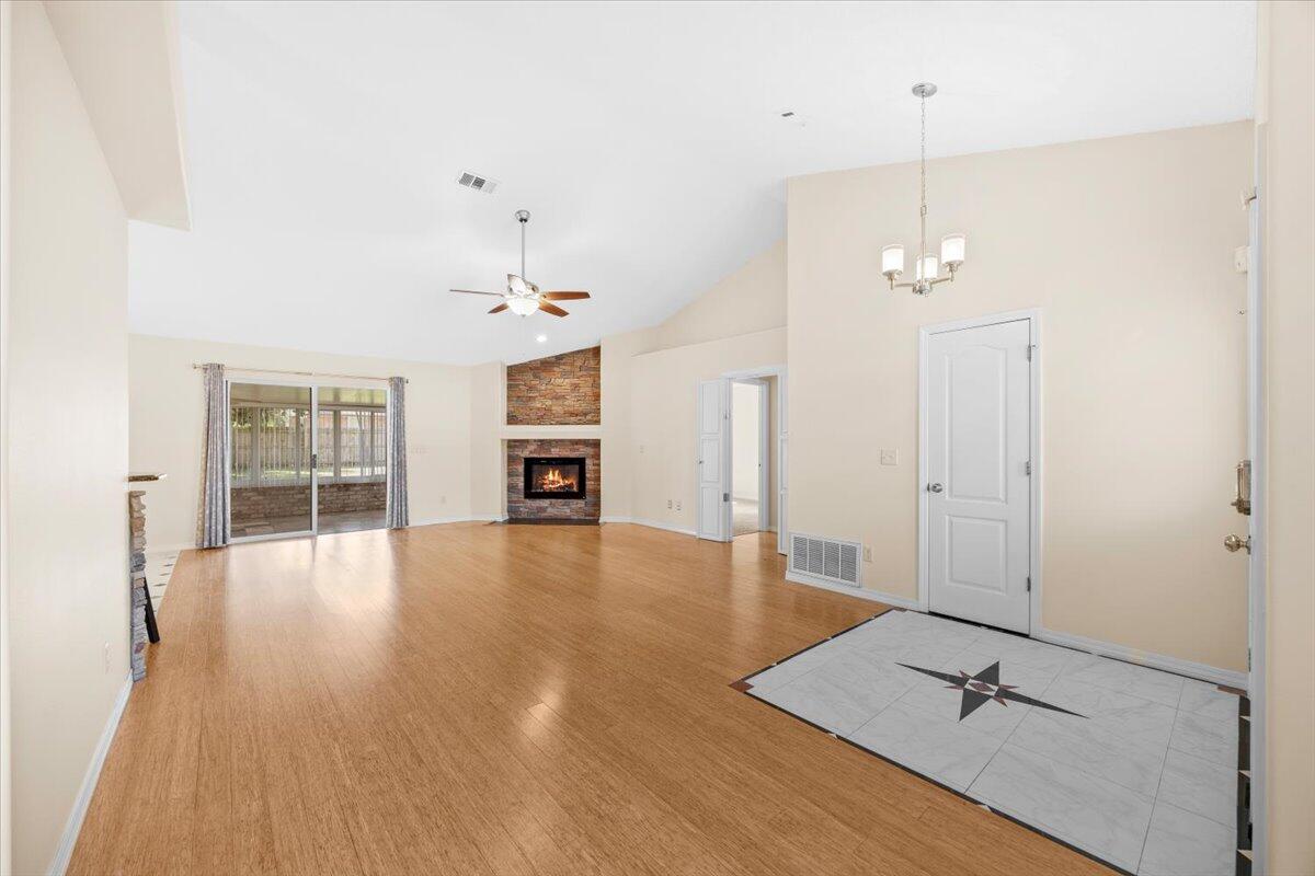 7807 Lola Circle Navarre, FL 32566 - Photo 9 of 45 wooden floor in an empty room with a window