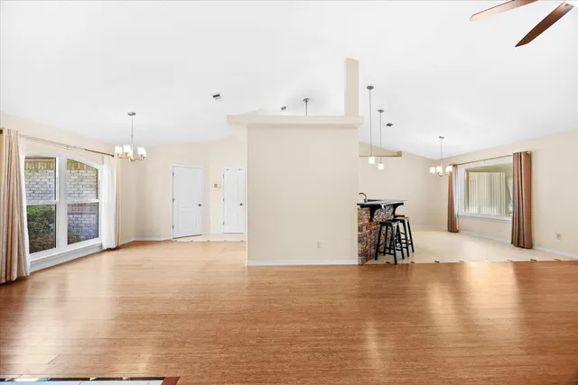 a kitchen with a table chairs refrigerator and cabinets