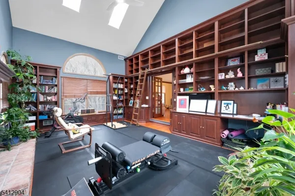 a room with lots of furniture and a potted plant