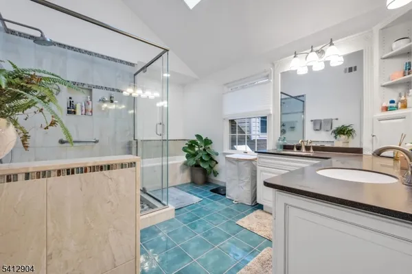 a spacious bathroom with a sink a large mirror and shower