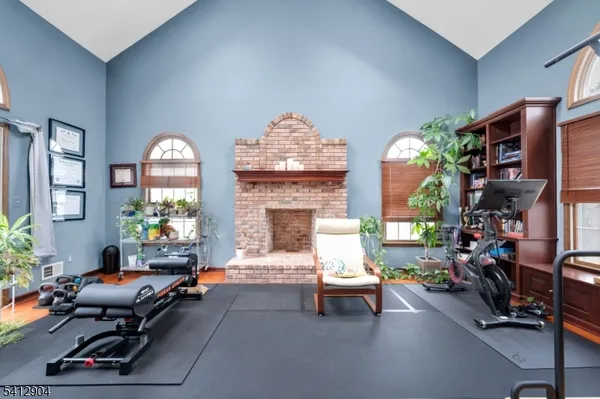 a living room with furniture a fireplace and a chandelier