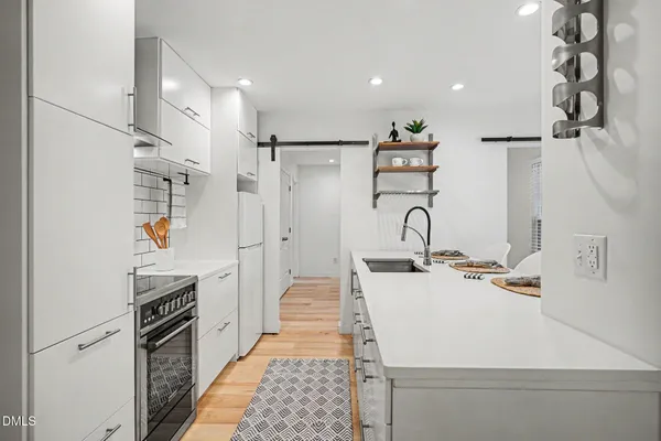 a kitchen with a refrigerator and a sink