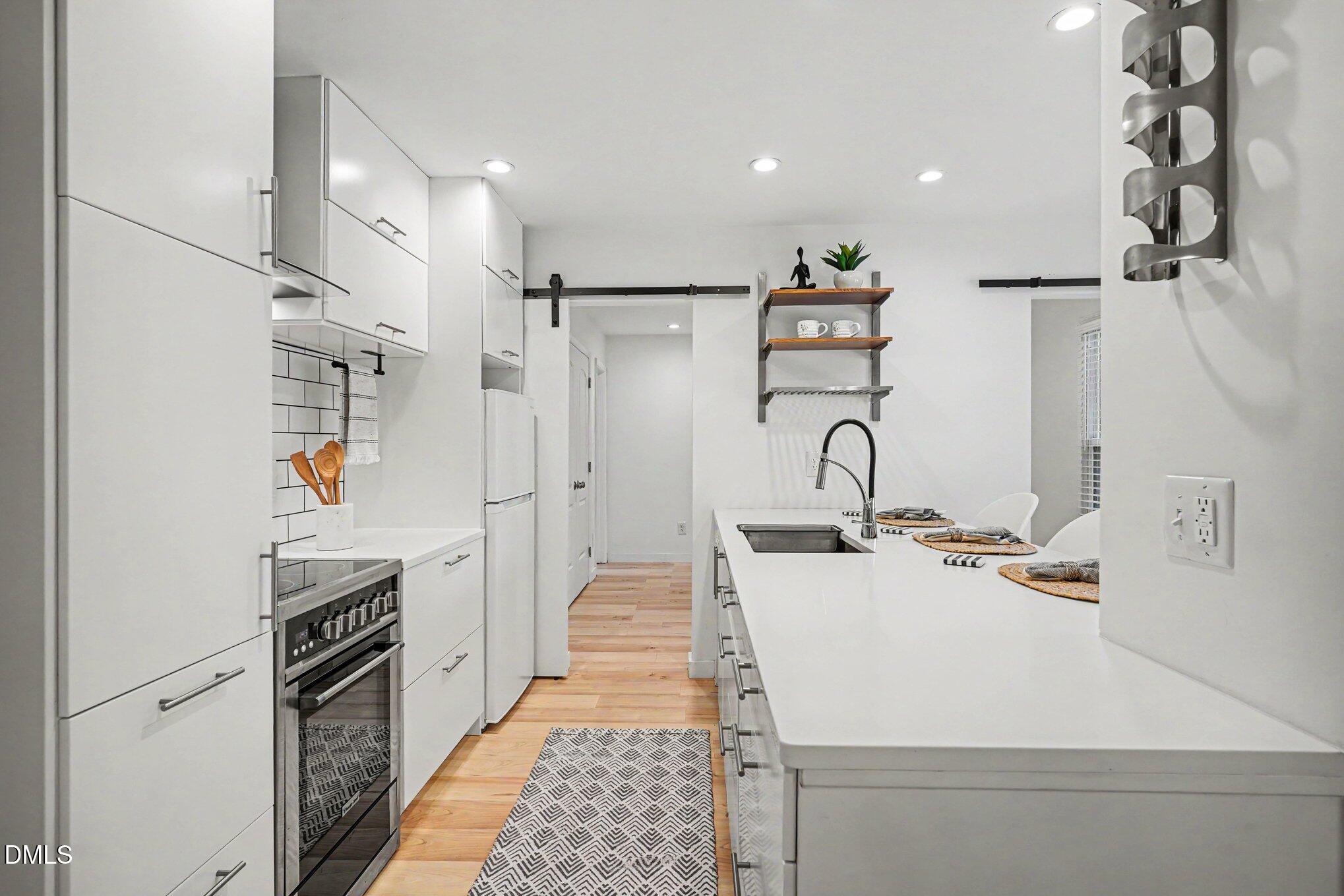 3555 Mill Run Raleigh, NC 27612 - Photo 1 of 25 a kitchen with a refrigerator and a sink