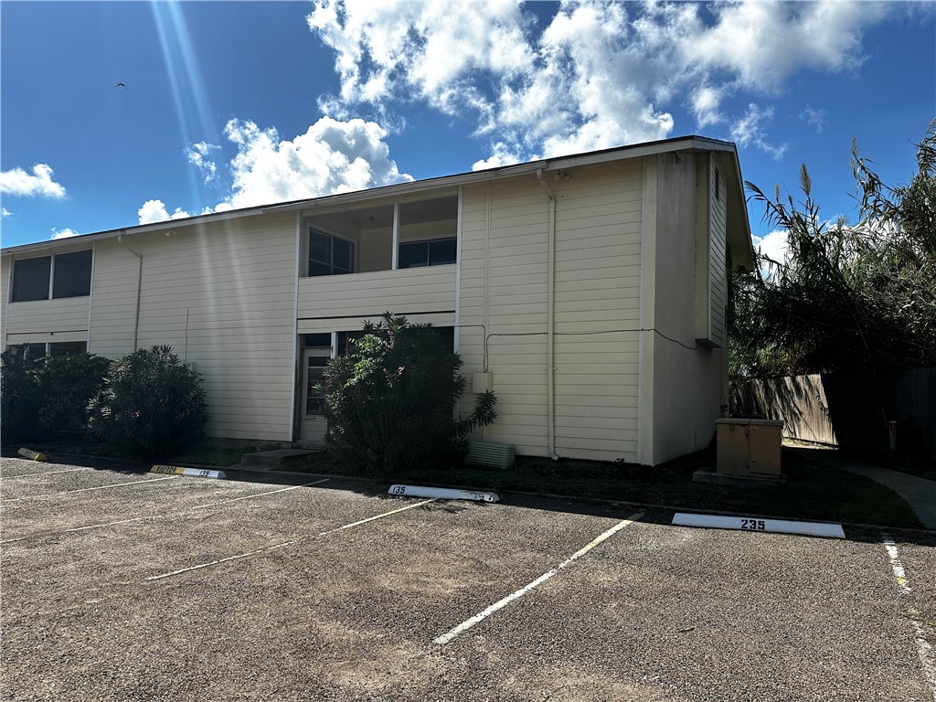 1011 Ennis Joslin Road, Unit 235 Corpus Christi, TX 78412 - Photo 19 of 20 a backyard of a house with plants and trees