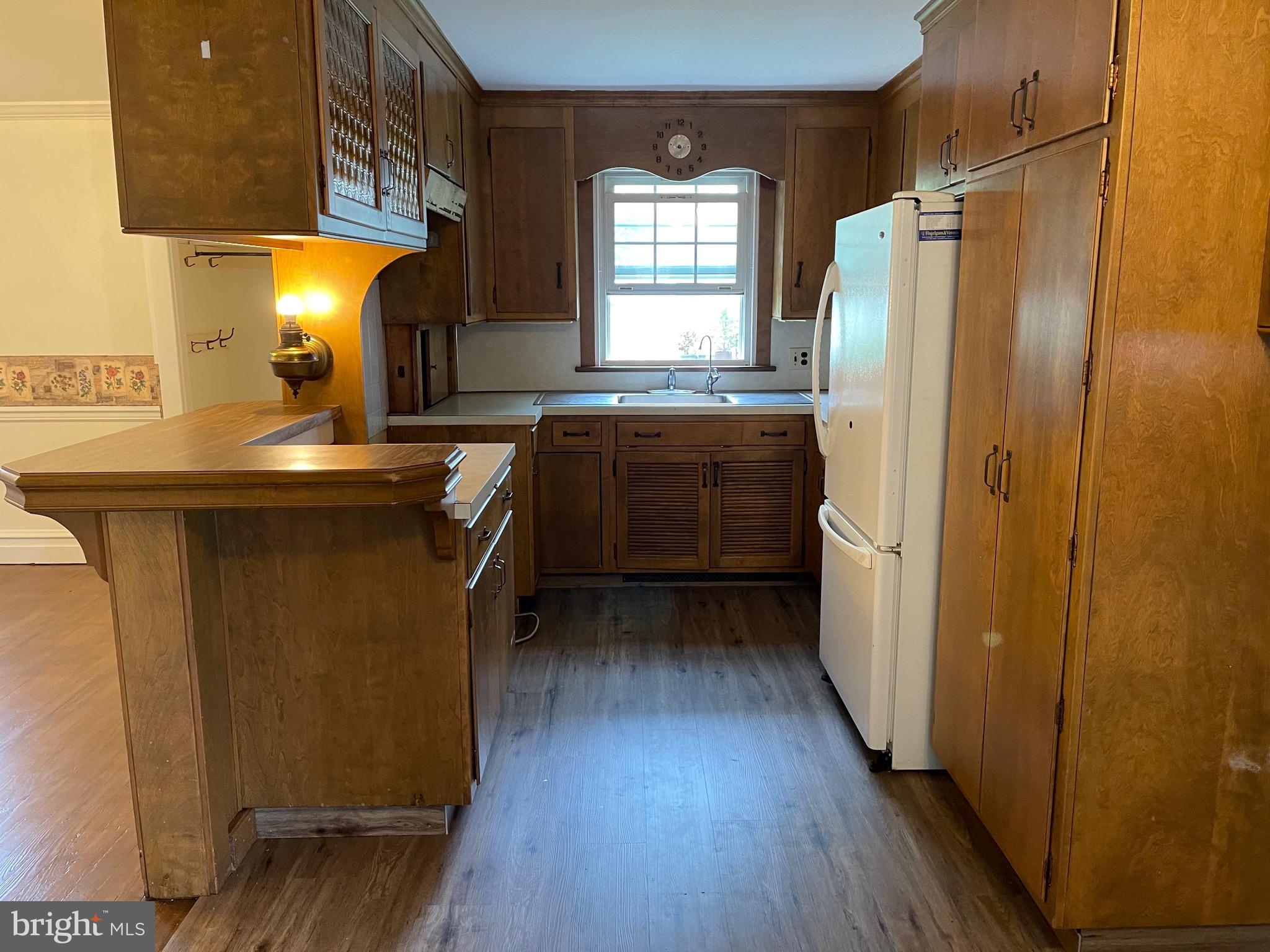 1083 Georgetown Road Paradise, PA 17562 - Photo 13 of 14 a kitchen with stainless steel appliances granite countertop a refrigerator a sink dishwasher a stove and white countertops with wooden floor