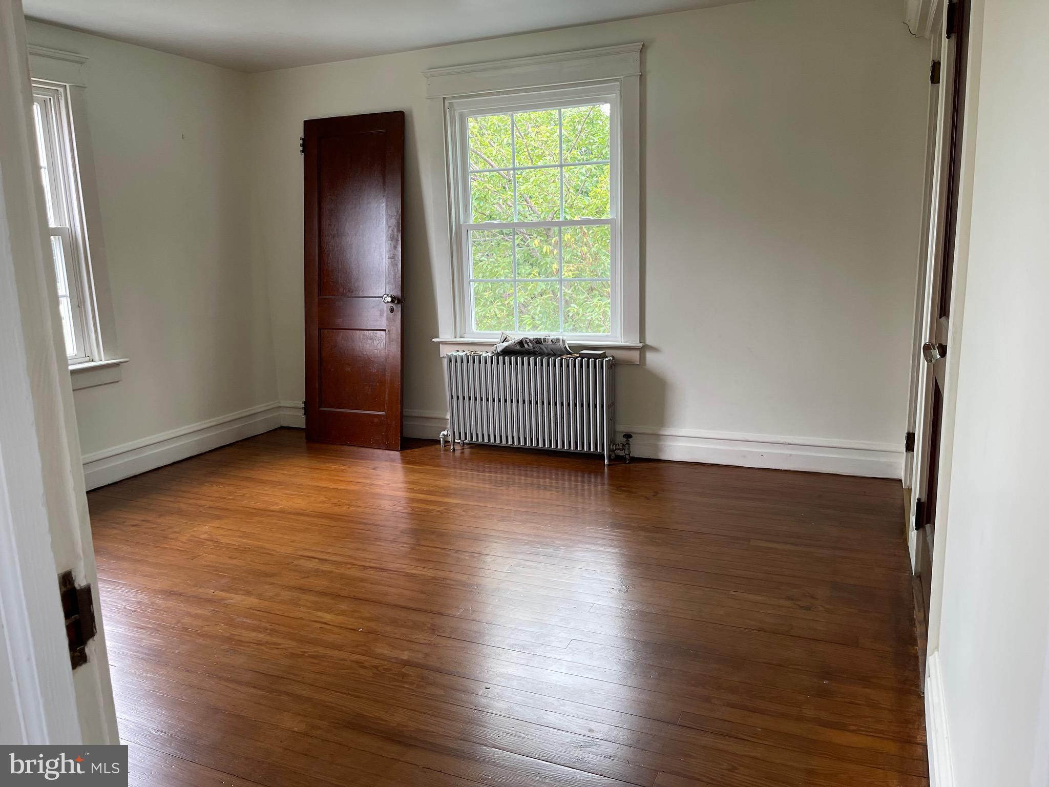 1083 Georgetown Road Paradise, PA 17562 - Photo 6 of 14 an empty room with wooden floor and windows