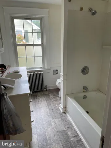 a bathroom with a bathtub and a window