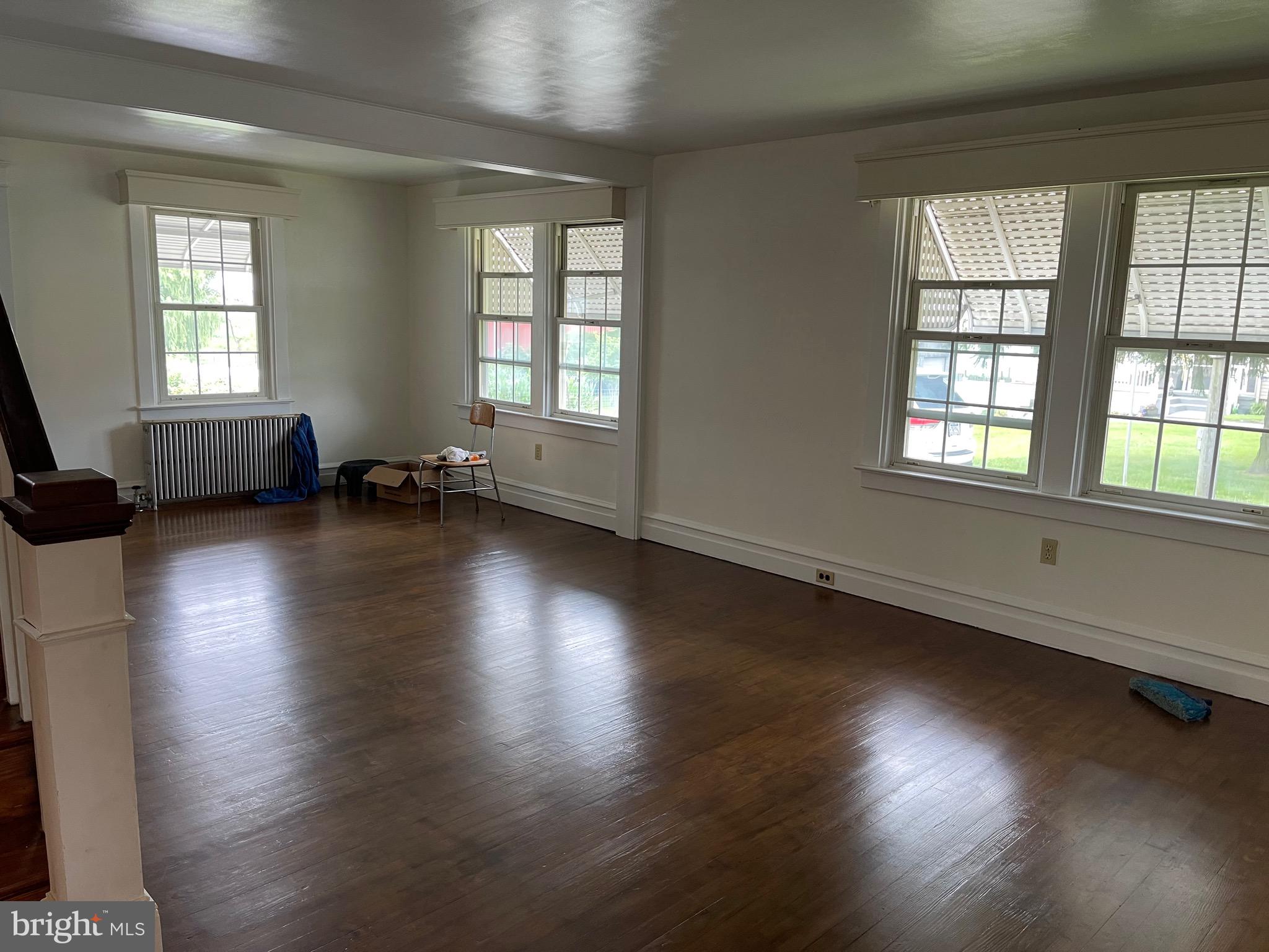 1083 Georgetown Road Paradise, PA 17562 - Photo 9 of 14 an empty room with wooden floor and windows