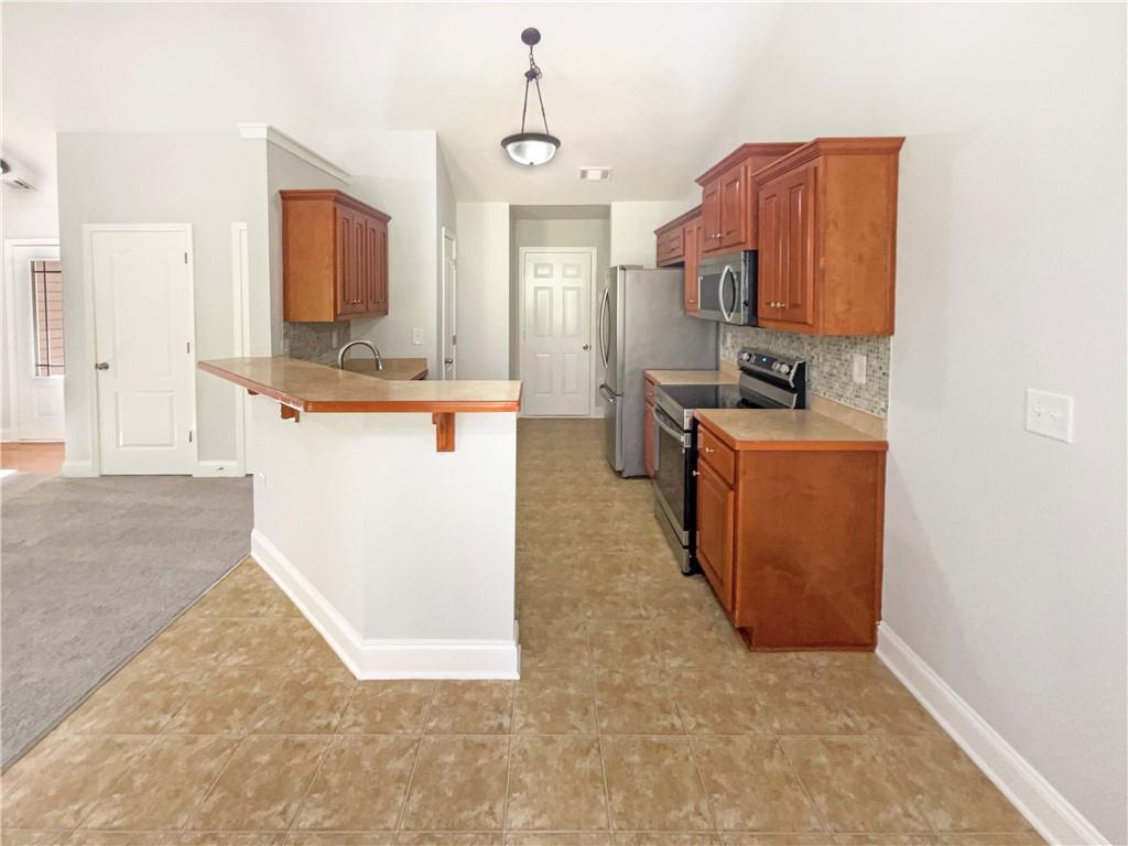 189 Hampton Drive Jefferson, GA 30549 - Photo 13 of 36 a kitchen with stainless steel appliances granite countertop a stove top oven a sink a counter top space and cabinets
