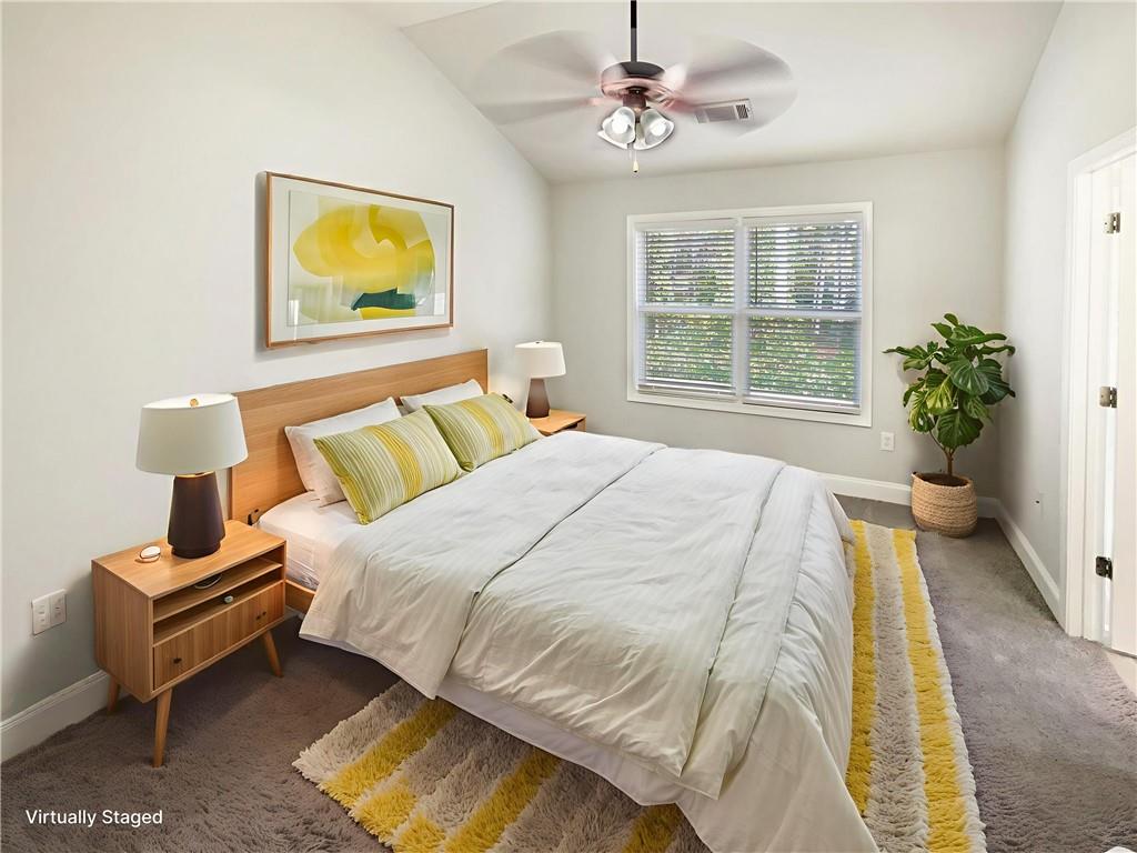 189 Hampton Drive Jefferson, GA 30549 - Photo 23 of 36 a spacious bedroom with a bed a painting on the wall and a potted plant