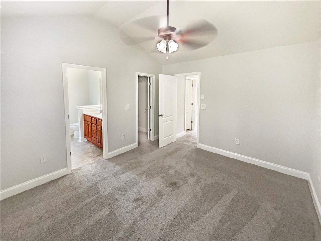 189 Hampton Drive Jefferson, GA 30549 - Photo 25 of 36 an empty room with chandelier fan and windows