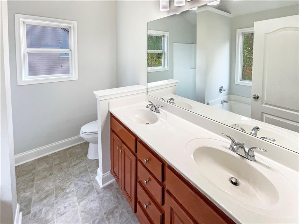189 Hampton Drive Jefferson, GA 30549 - Photo 28 of 36 a spacious bathroom with a sink double vanity and a toilet