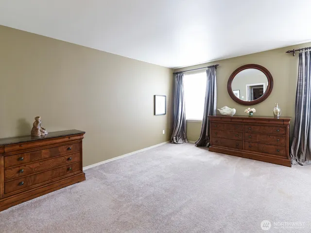 a room with a bed and a dresser