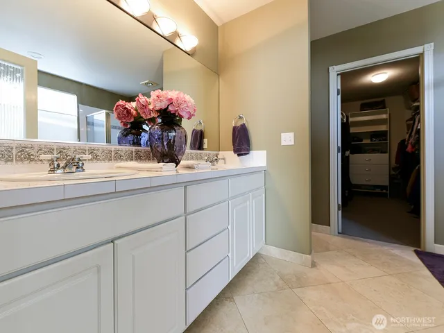 a bathroom with a sink vanity and mirror