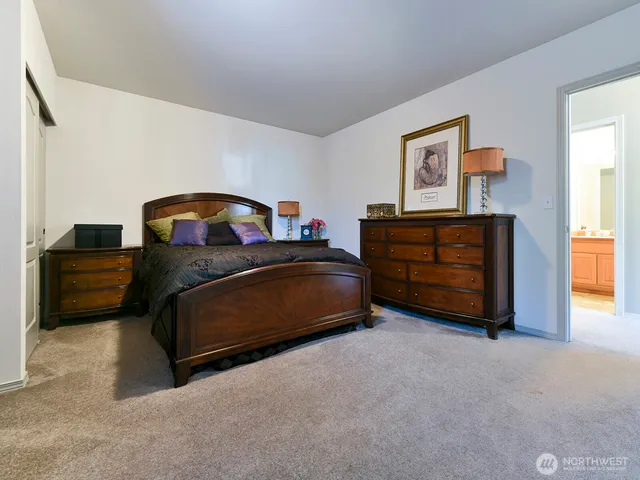 a bedroom with a bed and a couch