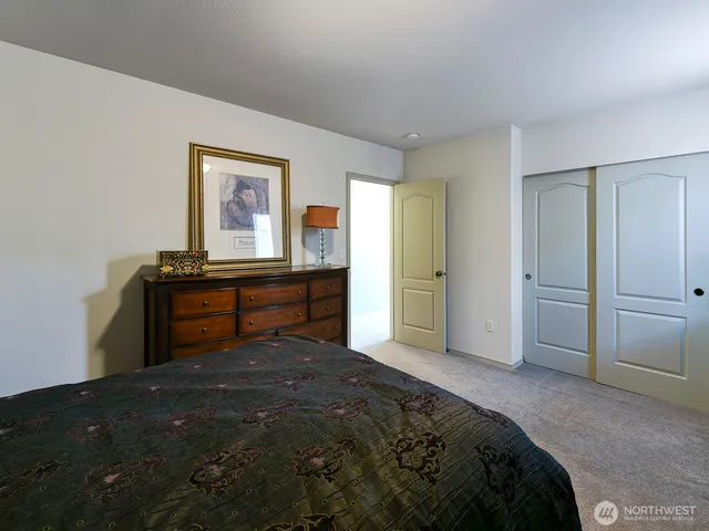 a bedroom with a bed and cabinet