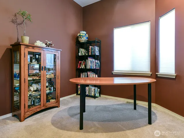 a room with pool table and windows
