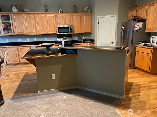 a kitchen with a sink a stove and a microwave