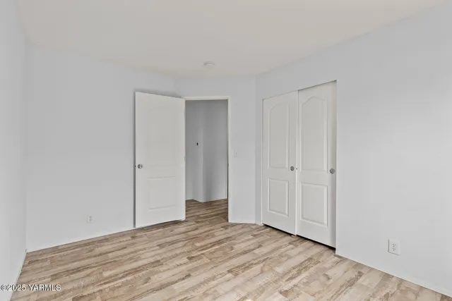 a view of an empty room and wooden floor