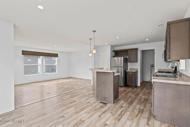 a kitchen with a refrigerator and a sink