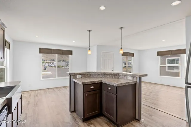 a kitchen with granite countertop a stove and a wooden floors
