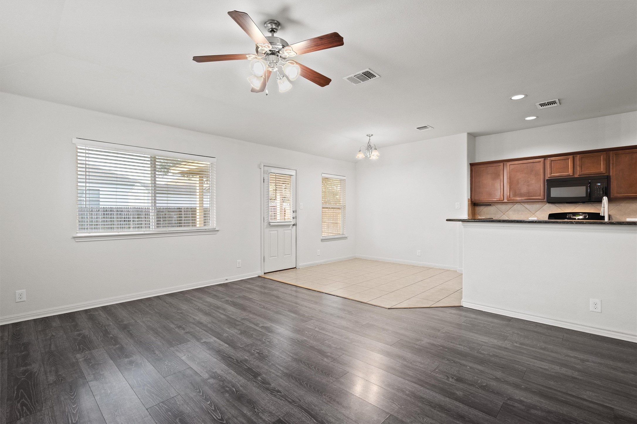 1612 Musket Valley Trail Austin, TX 78754 - Photo 12 of 34 a view of an empty room with window and wooden floor