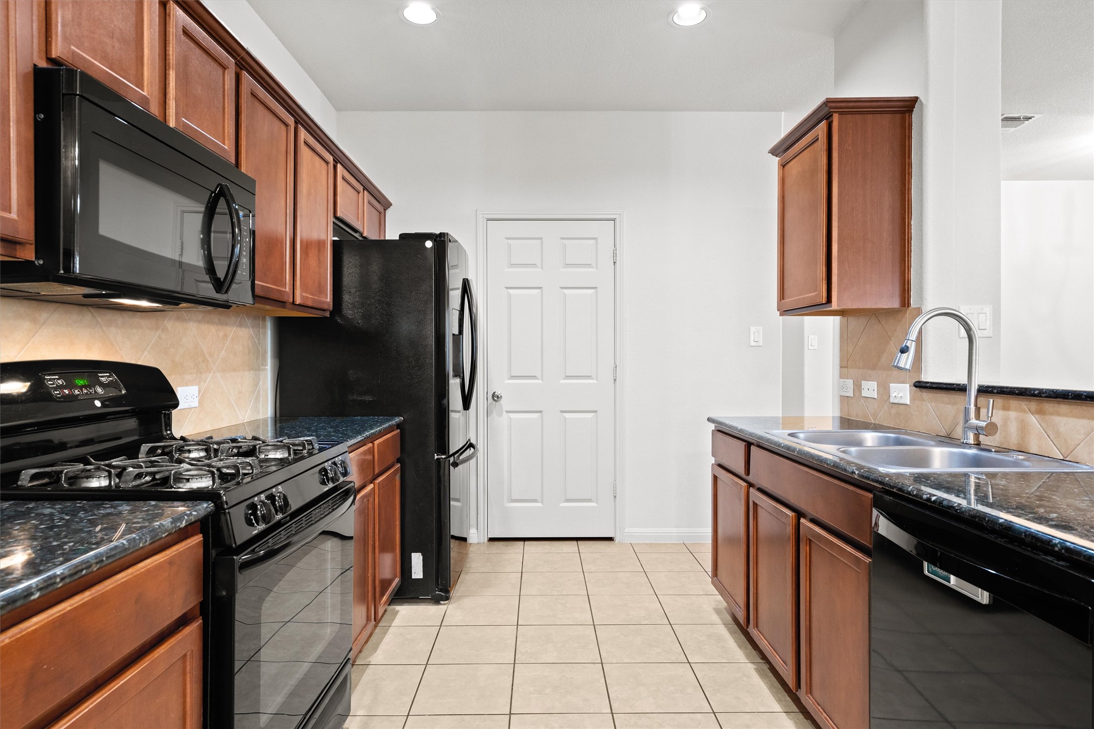 1612 Musket Valley Trail Austin, TX 78754 - Photo 15 of 34 a kitchen with stainless steel appliances granite countertop a sink stove and cabinets