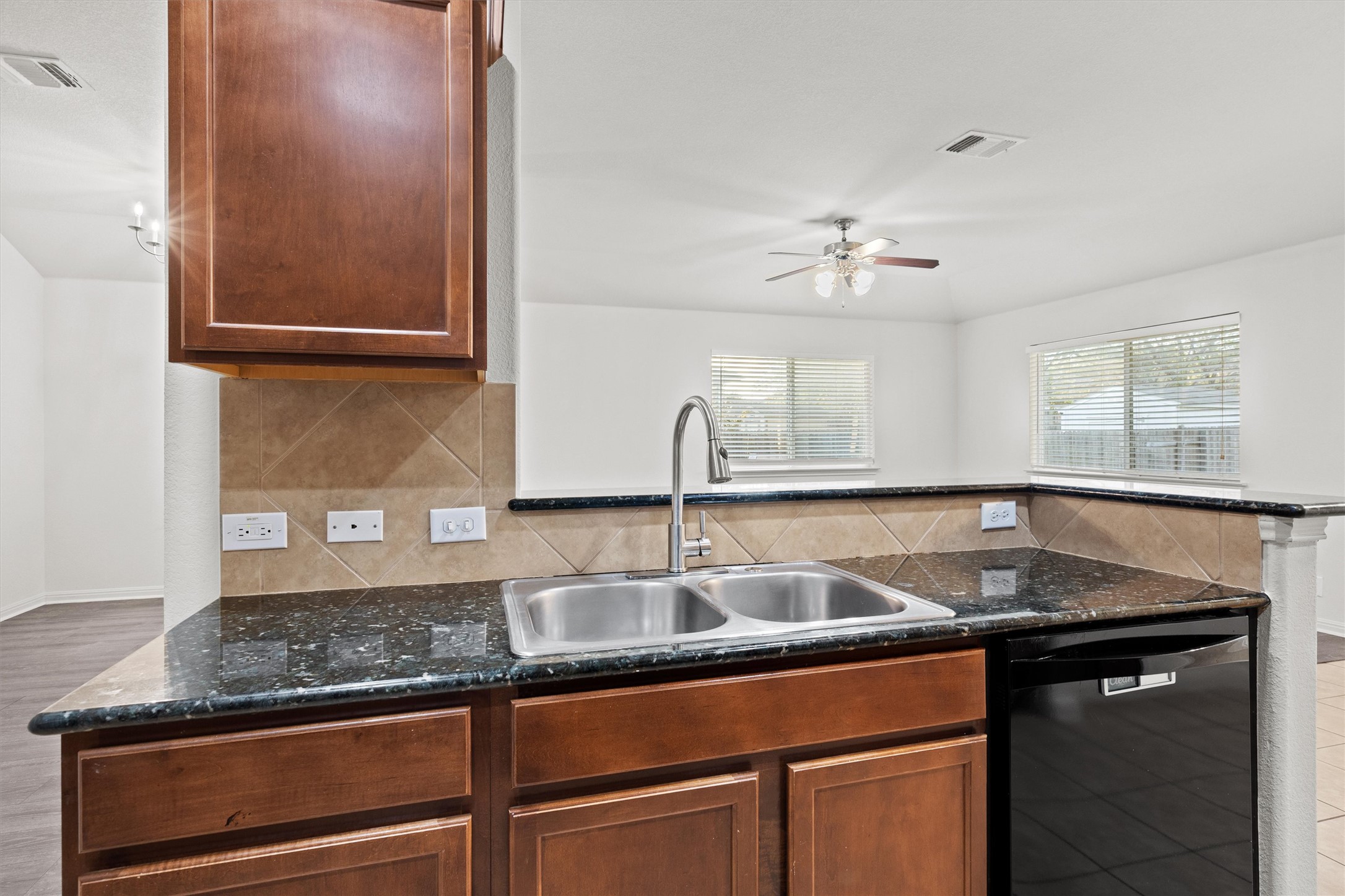 1612 Musket Valley Trail Austin, TX 78754 - Photo 18 of 34 a kitchen with granite countertop a sink and a cabinets