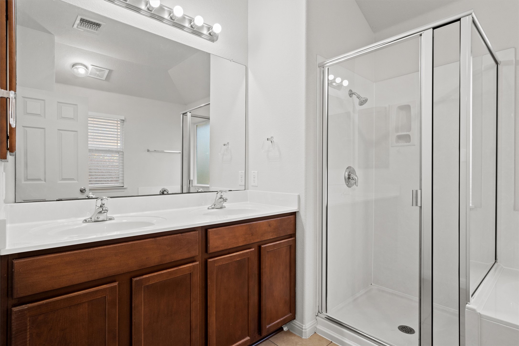 1612 Musket Valley Trail Austin, TX 78754 - Photo 21 of 34 a bathroom with a double vanity sink mirror and shower