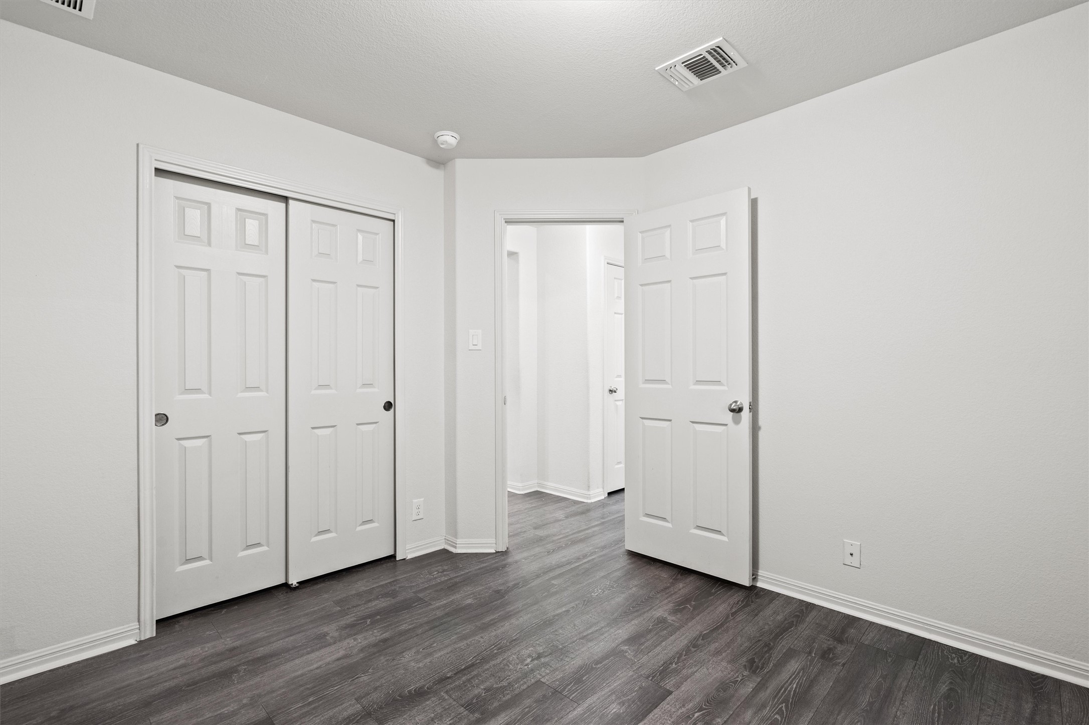 1612 Musket Valley Trail Austin, TX 78754 - Photo 27 of 34 a view of an empty room with wooden floor