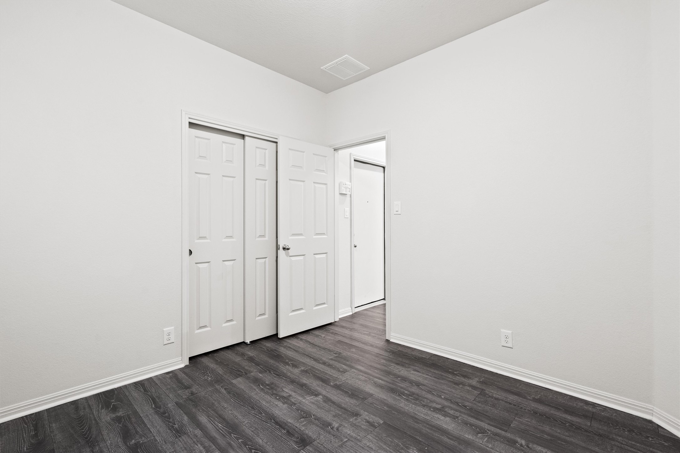 1612 Musket Valley Trail Austin, TX 78754 - Photo 29 of 34 a view of an empty room with wooden floor