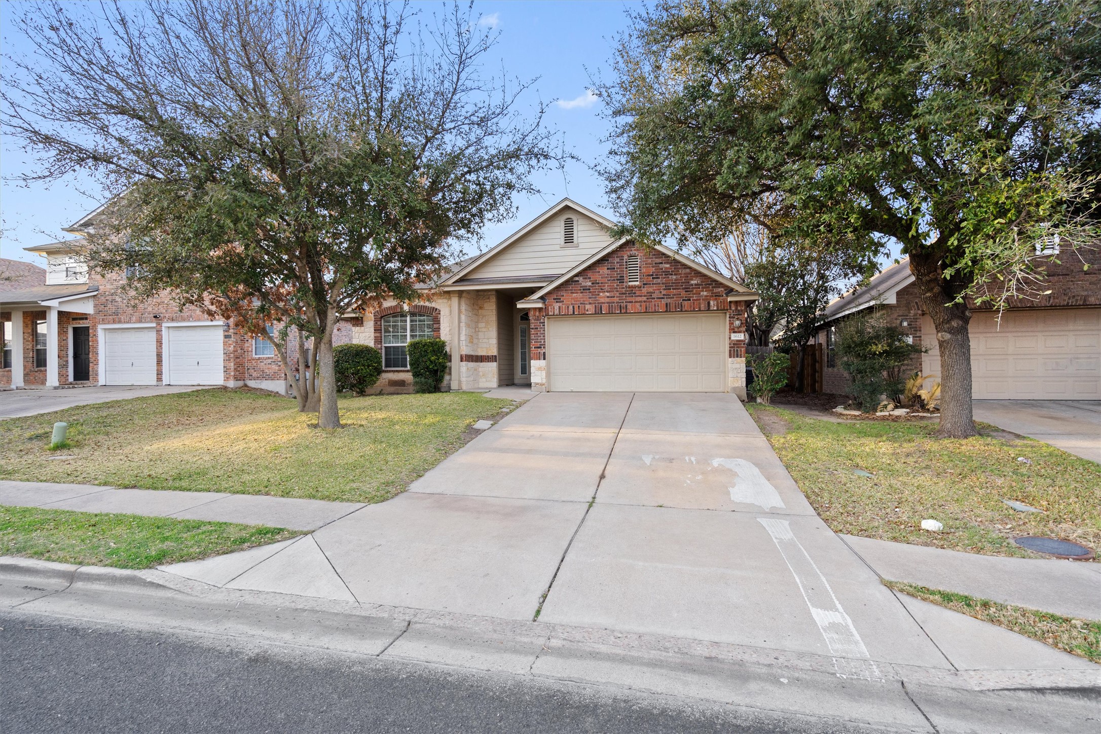 1612 Musket Valley Trail Austin, TX 78754 - Photo 3 of 34 a house with yard and a trees in front of it