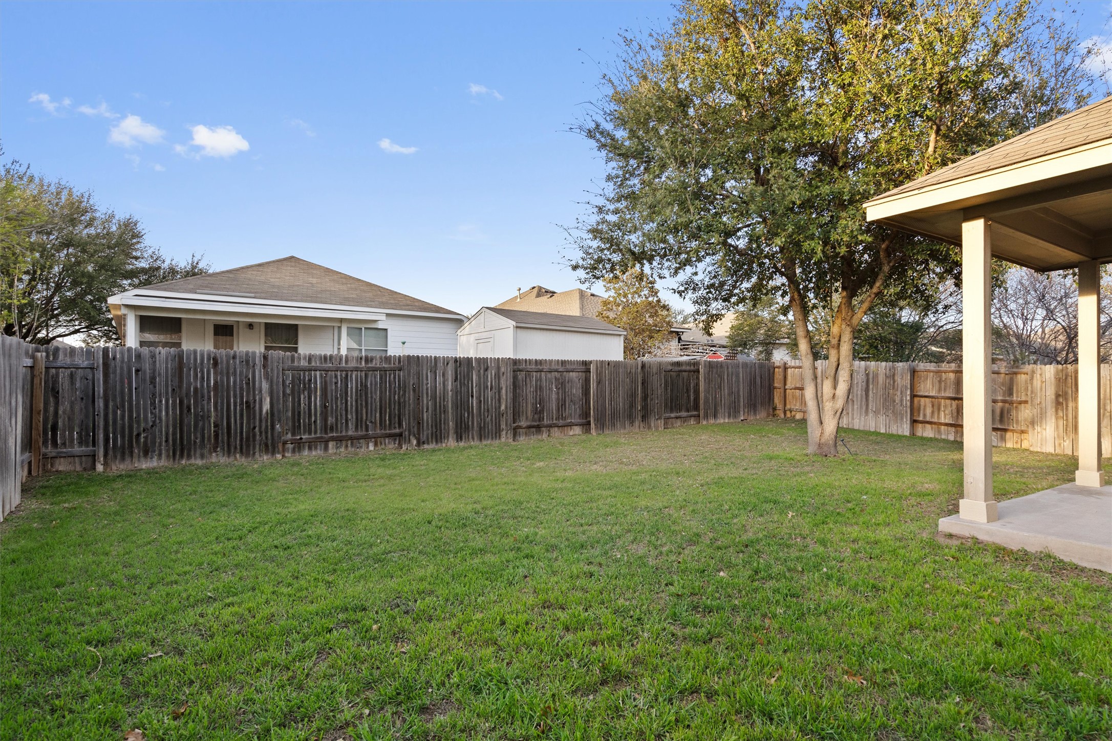 1612 Musket Valley Trail Austin, TX 78754 - Photo 31 of 34 a view of a yard with wooden fence and a bench