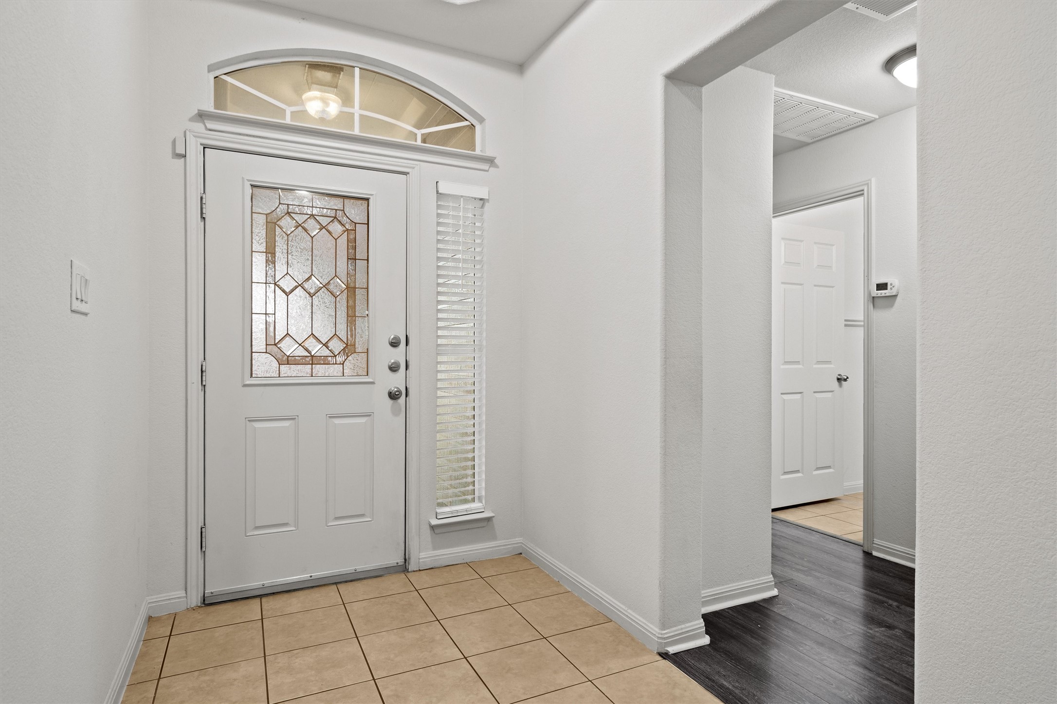 1612 Musket Valley Trail Austin, TX 78754 - Photo 5 of 34 an empty room with wooden floor mirror and door