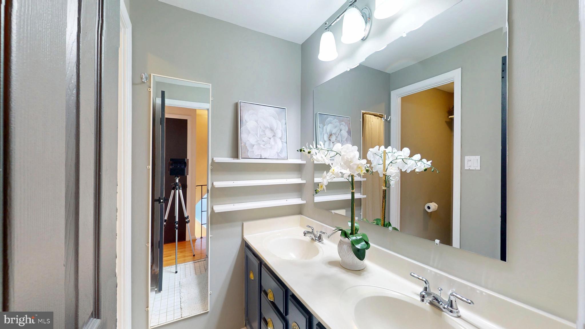 1771 Whisperhill Drive Reston, VA 20194 - Photo 25 of 44 a bathroom with a sink vanity and a mirror