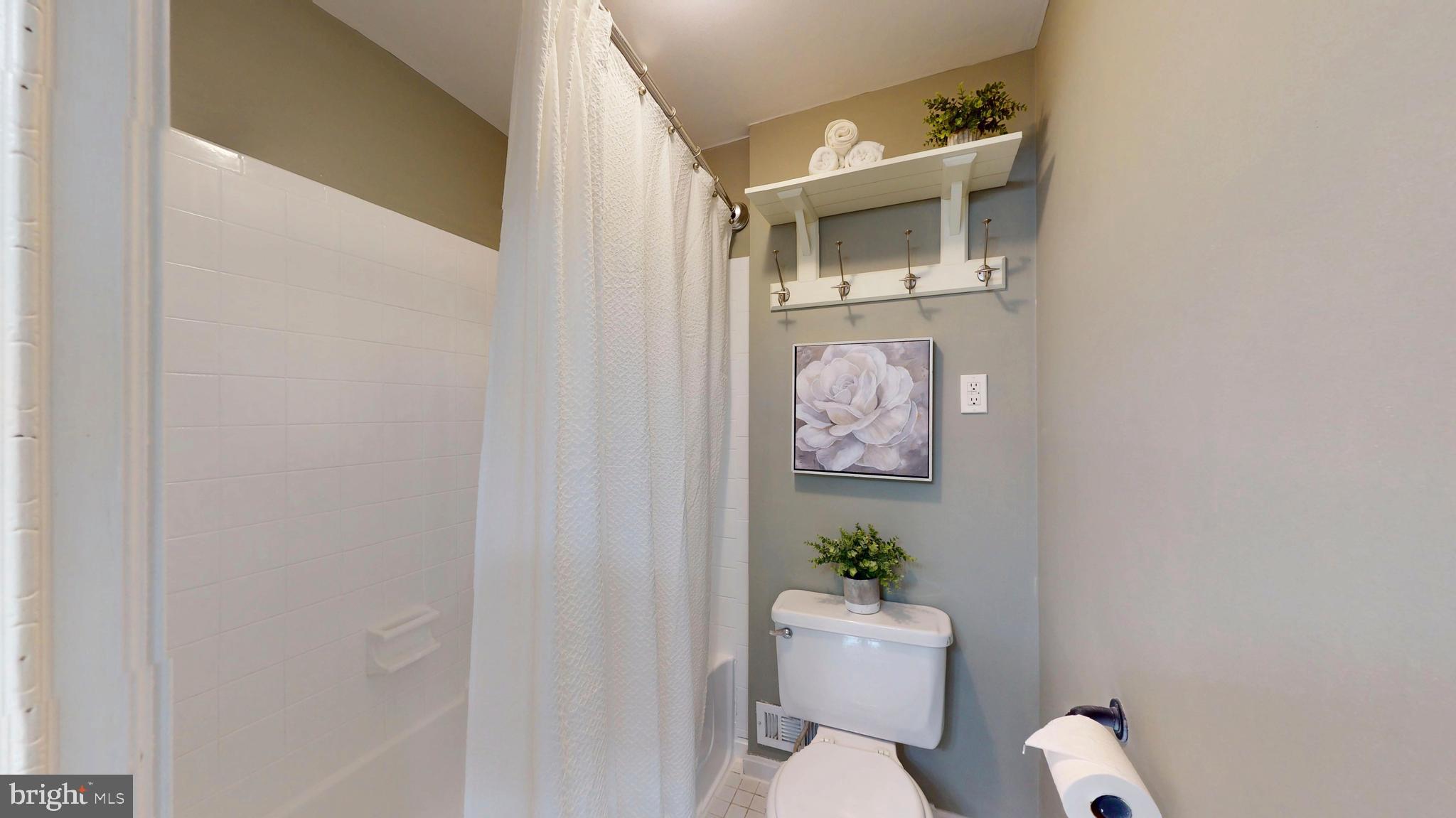 1771 Whisperhill Drive Reston, VA 20194 - Photo 26 of 44 a white toilet sitting next to a bathroom sink