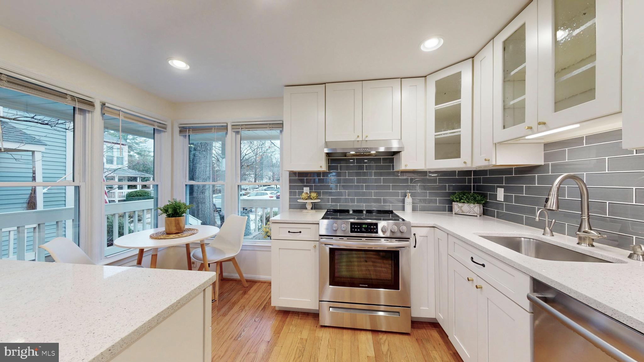 1771 Whisperhill Drive Reston, VA 20194 - Photo 6 of 44 a kitchen with a stove a sink and white cabinets