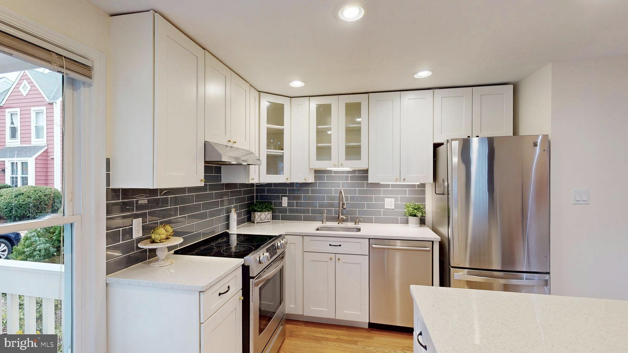 1771 Whisperhill Drive Reston, VA 20194 - Photo 7 of 44 a kitchen with a stove a sink and a refrigerator