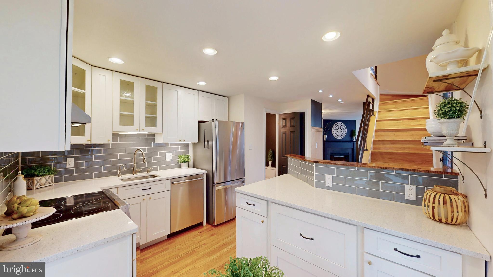 1771 Whisperhill Drive Reston, VA 20194 - Photo 8 of 44 a kitchen with a sink and refrigerator