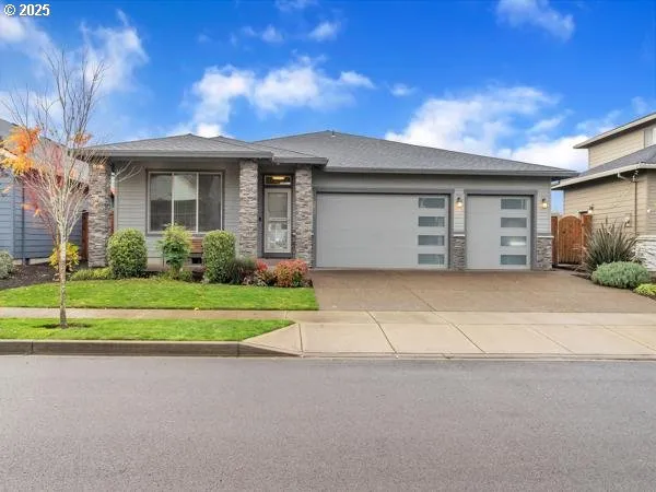 a front view of a house with a yard and garage