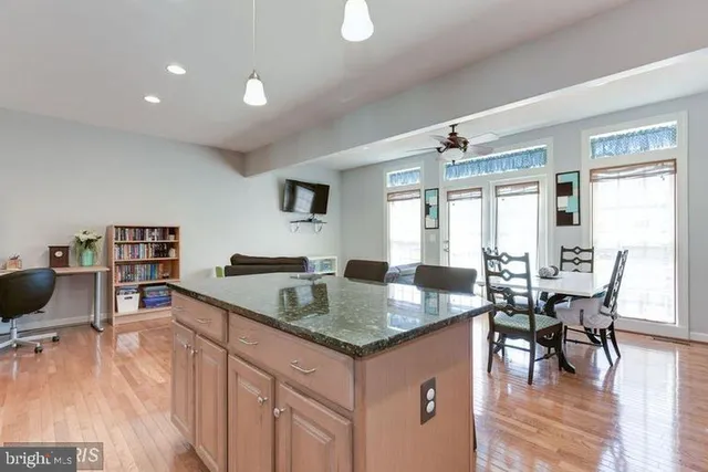 a open kitchen with granite countertop a sink and a stove