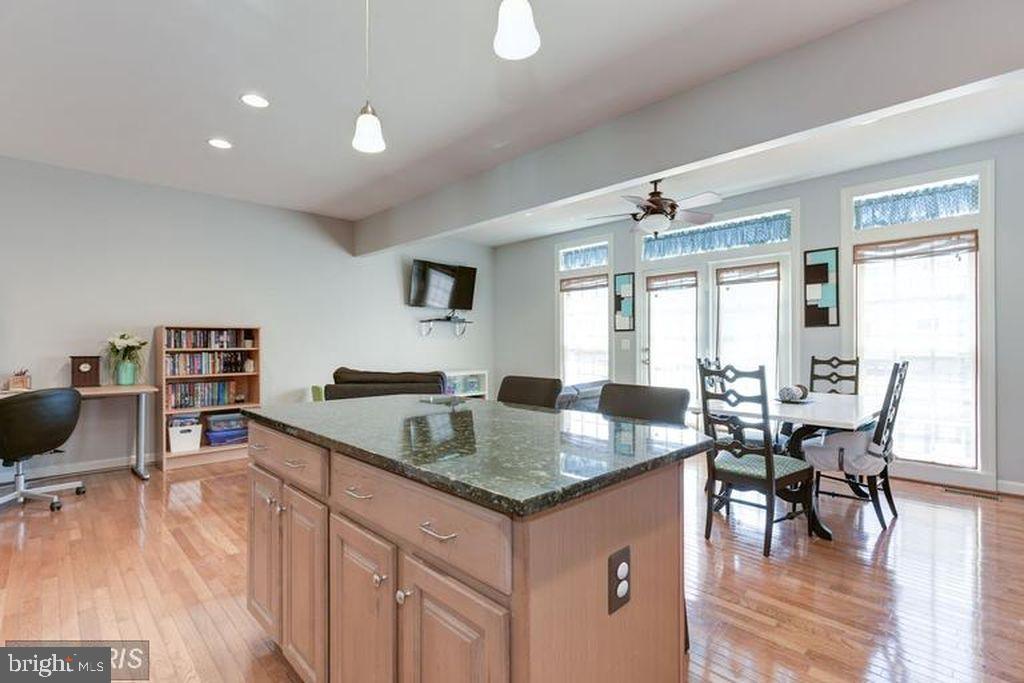 25259 Destination Square Aldie, VA 20105 - Photo 11 of 28 a open kitchen with granite countertop a sink and a stove