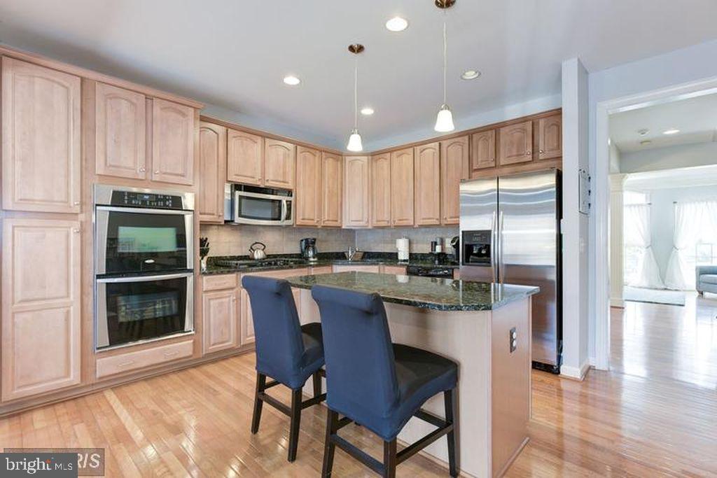 25259 Destination Square Aldie, VA 20105 - Photo 12 of 28 a kitchen with stainless steel appliances granite countertop a refrigerator a stove top oven a sink and dishwasher