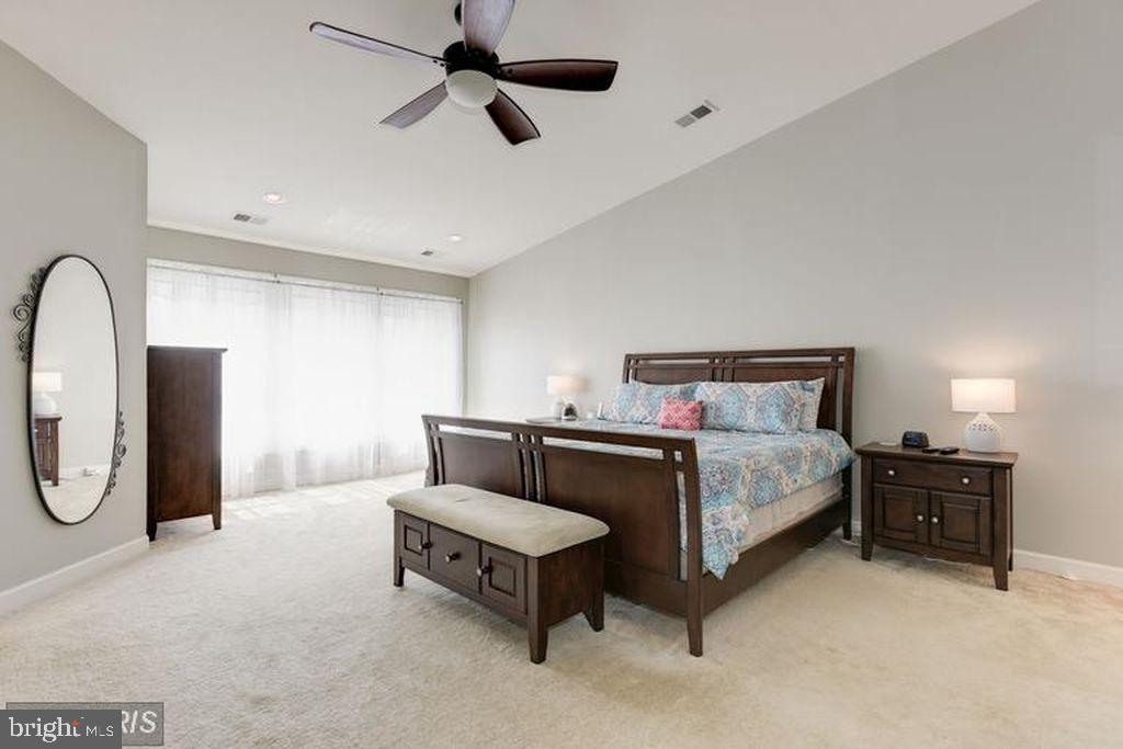 25259 Destination Square Aldie, VA 20105 - Photo 15 of 28 a spacious bedroom with a bed and ceiling fan