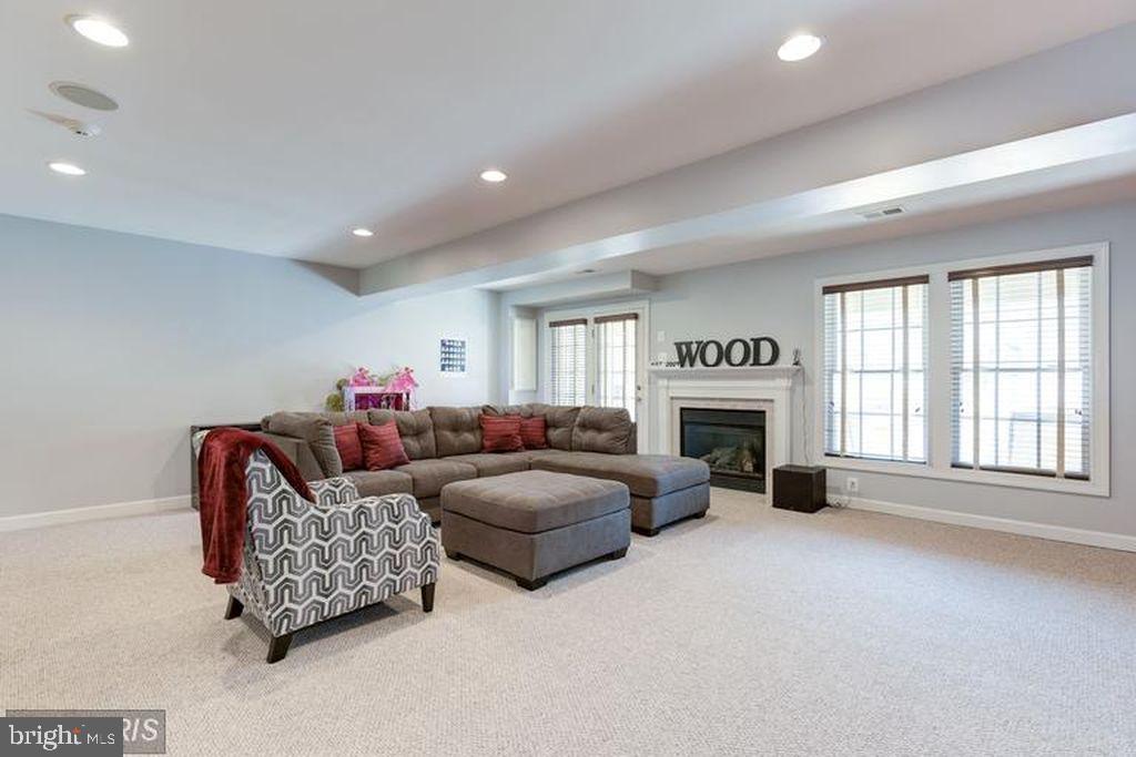 25259 Destination Square Aldie, VA 20105 - Photo 22 of 28 a living room with furniture a fireplace and a large window