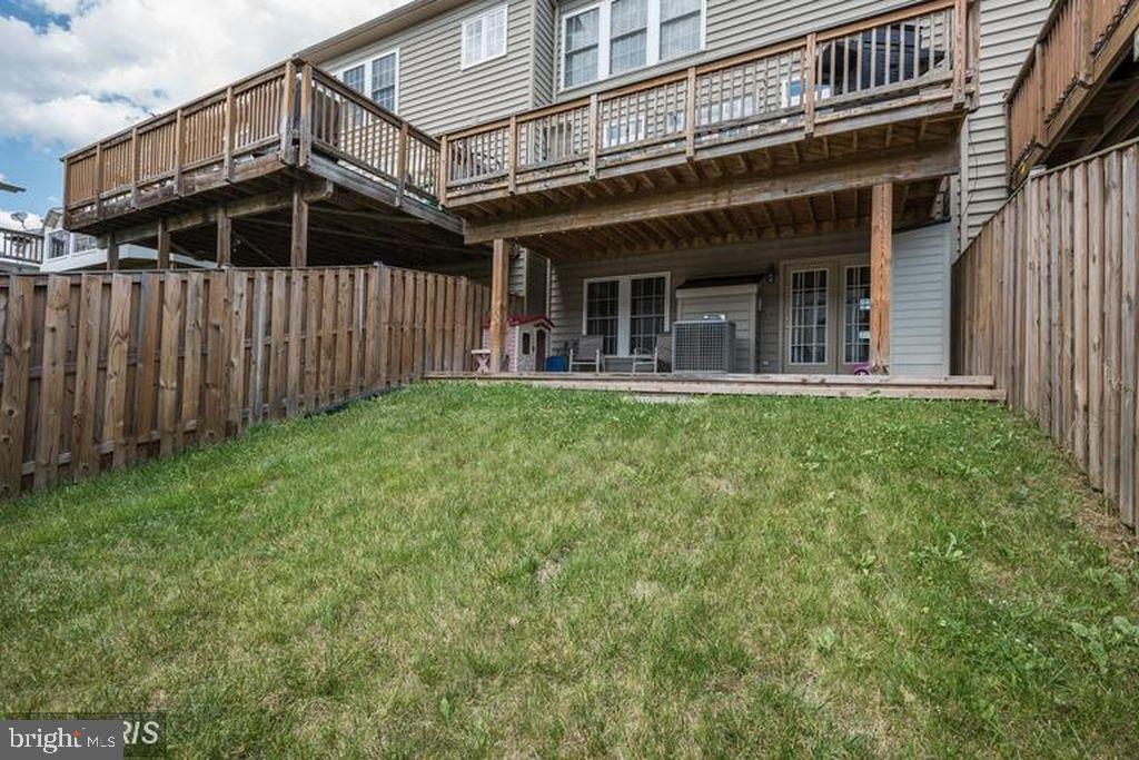 25259 Destination Square Aldie, VA 20105 - Photo 27 of 28 a view of a house with wooden walls and a yard