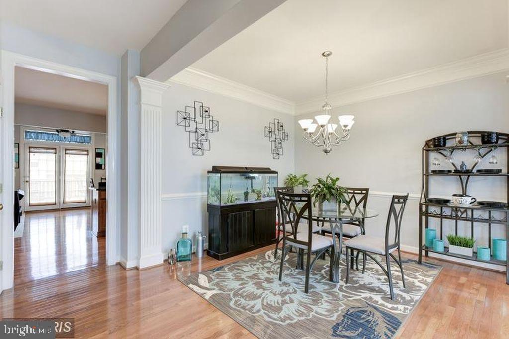 25259 Destination Square Aldie, VA 20105 - Photo 8 of 28 a dining room with furniture a chandelier and wooden floor