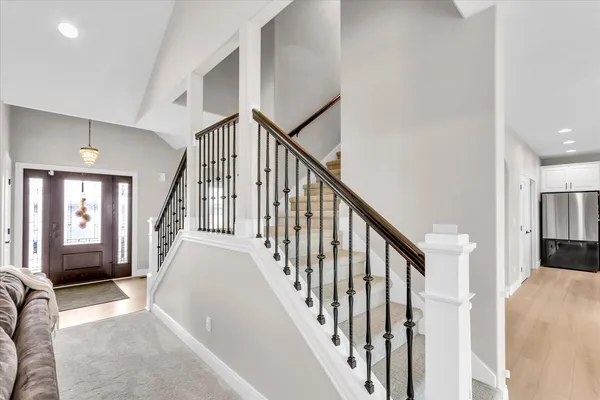 a kitchen with stainless steel appliances granite countertop a stove a sink a refrigerator and a microwave