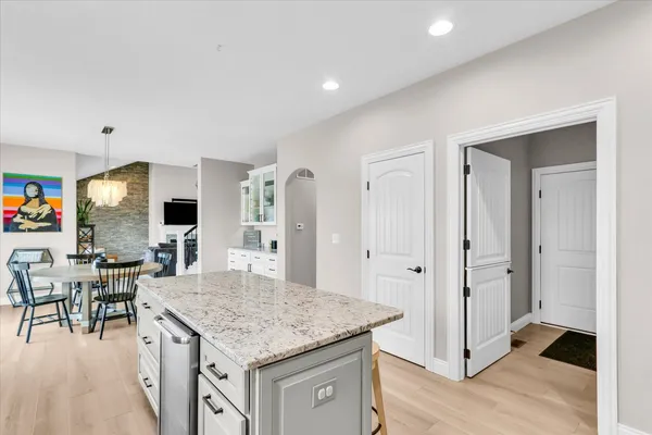 a dining room with furniture a chandelier and wooden floor
