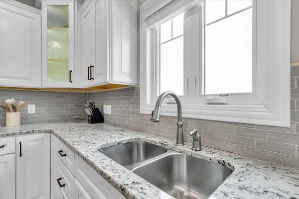 a large kitchen with a table and chairs